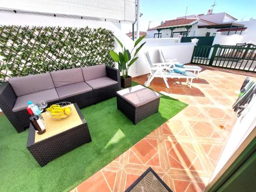 a patio with a couch and a table on a balcony at Mucha Vida in Abades