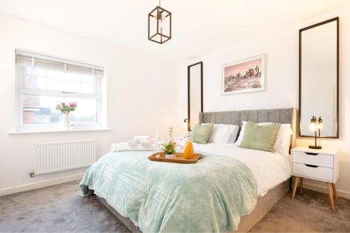 a white bedroom with a bed with a tray on it at Shinfield Studio Luxury Stay - 2 Parking - Family & Business in Shinfield