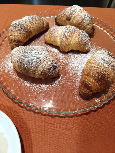 a tray of pastries on a table with powdered sugar at Hostel il Tetto in Melfi