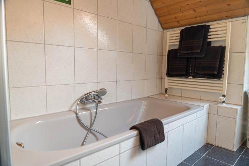 a bathroom with a bath tub with a shower at Hotel & Restaurant Zum Reussenstein in Böblingen
