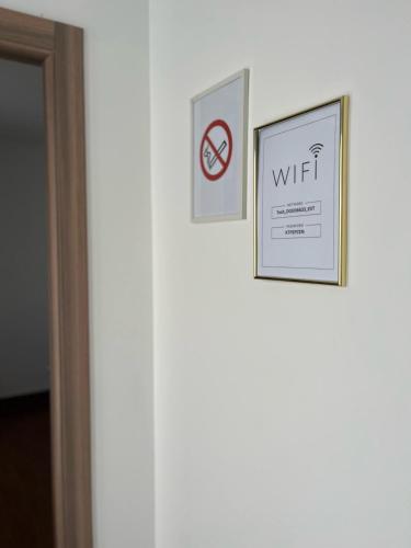 two pictures hanging on a wall next to a door at Surčin Apartment in Ledine