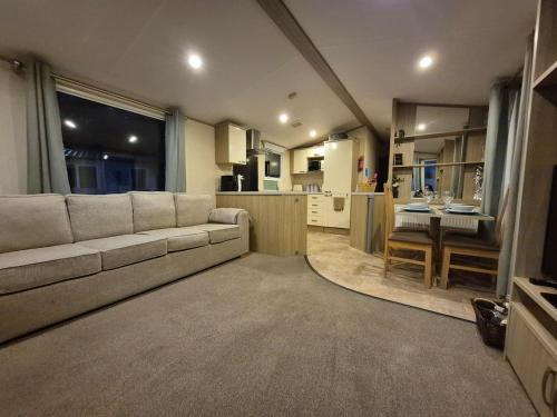 a living room with a couch and a kitchen at Sapphire in Saint Leonards