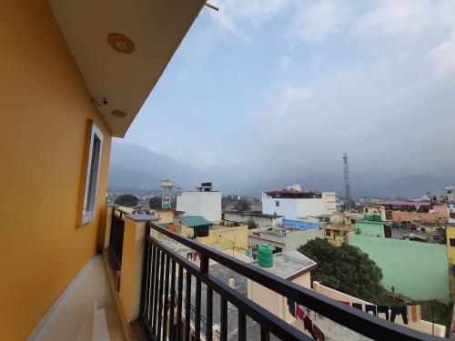 a balcony with a view of a city at Hotel Suraj in Rishīkesh