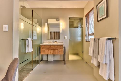 a bathroom with a sink and a mirror at WINK Aparthotel Foreshore in Cape Town