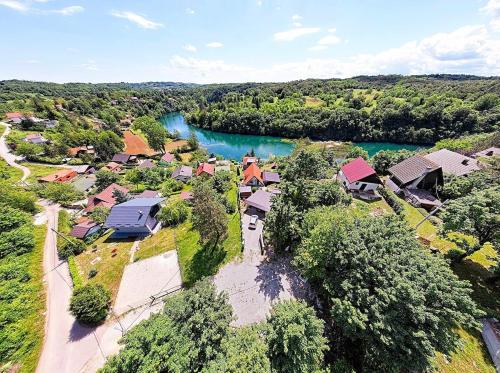 an aerial view of a village with a river at Harmony - with jacuzzi and sauna in Donji Zvečaj