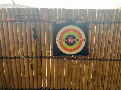 a stack of books with a target on top of them at OneWorldLove Garden in Woy Woy