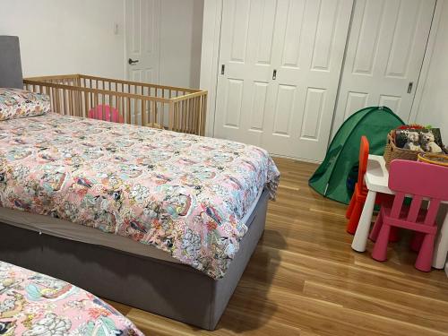 a bedroom with two beds and a table and chairs at OneWorldLove Garden in Woy Woy