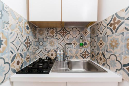 a kitchen with a sink and a stove at Luxury 12 in Tuglie