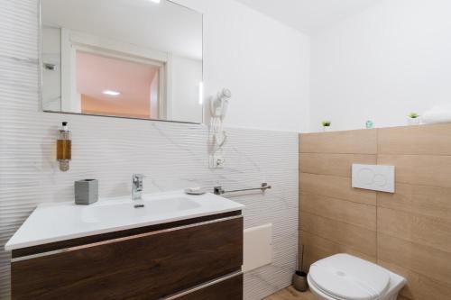 a bathroom with a sink and a toilet at Luxury 12 in Tuglie