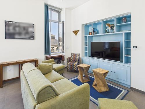 a living room with a couch and a tv at -LE BOUDOIR- Elegant T2 Concarneau hypercentre in Concarneau