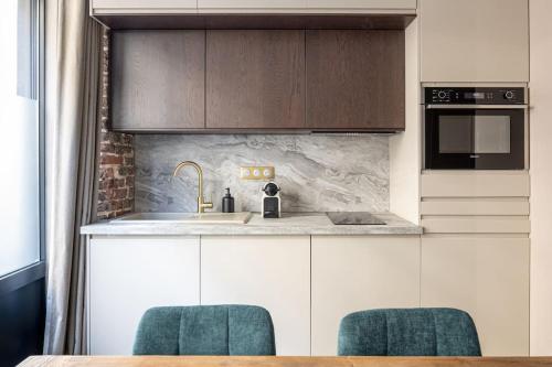 a kitchen with a sink and a counter top at My Boudoir in Paris