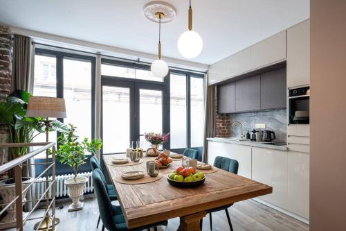 a kitchen with a wooden table with a bowl of fruit on it at My Boudoir in Paris