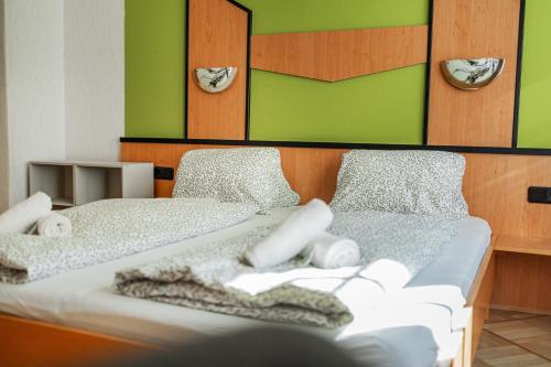 a bedroom with two beds with towels on them at Vienna West Business Inn in Vienna