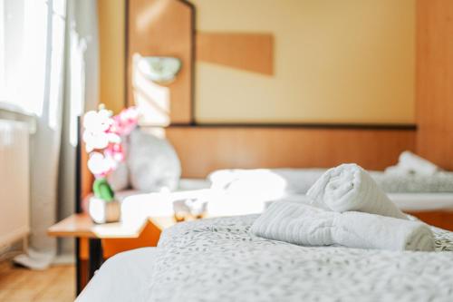 a bedroom with a bed with towels on it at Vienna West Business Inn in Vienna