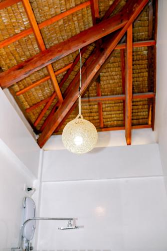 a chandelier hanging from a ceiling in a bathroom at Villa De Mikaël in General Luna