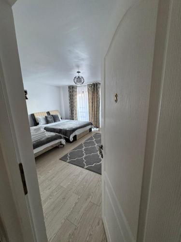 a hallway to a living room with a couch at Casa Popescu in Călimăneşti