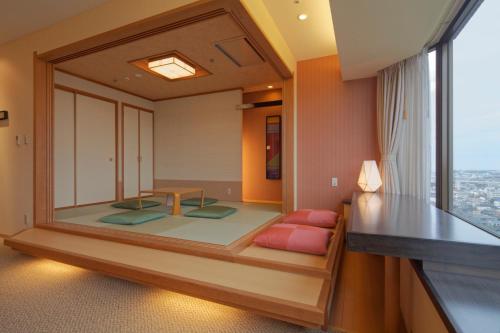 a room with a meditation room with a large window at Kanazawa Tokyu Hotel in Kanazawa