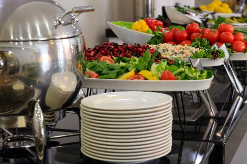 a tray of food on a table with a plate of vegetables at Armenia Hotel in Jermuk