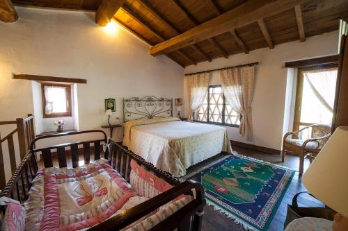 a bedroom with a bed and a couch in a room at Ferienhaus In Vergemoli Mit Schönem Kamin in Vergemoli