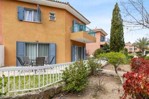 a house with a white fence at Limnaria Gardens SUPERB VILLA by VICHY Holidays in Paphos