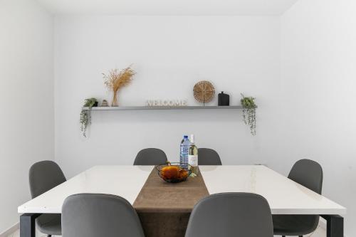 a dining room with a table and chairs at Limnaria Gardens SUPERB VILLA by VICHY Holidays in Paphos