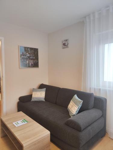 a living room with a couch and a coffee table at Hotel & Restaurant Zum Reussenstein in Böblingen