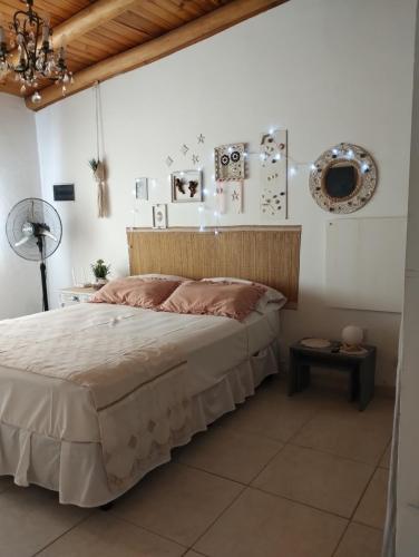 a bedroom with a large bed with a wooden headboard at Planeta Relax in San Rafael