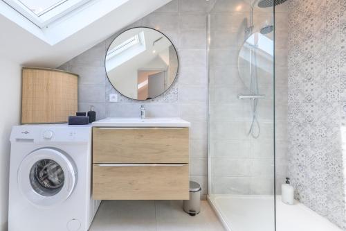 La salle de bains est pourvue d'un lave-linge et d'un miroir. dans l'établissement Le cœur des Alpes, à Grenoble
