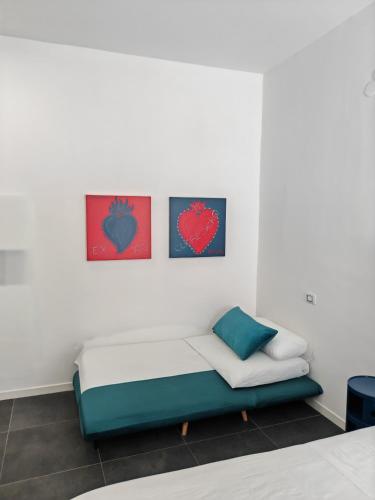 a couch in a room with two hearts on the wall at Art Street Hotel in Naples