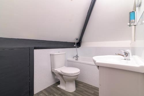 a bathroom with a white toilet and a sink at The Wheeldale in Whitby