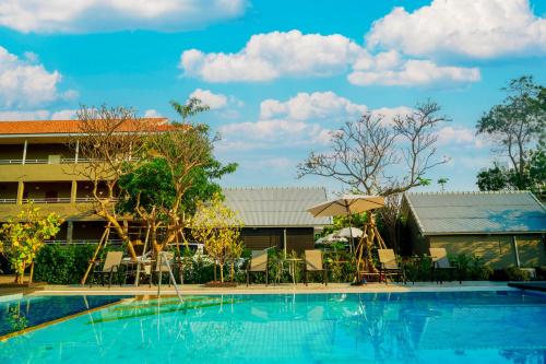 a large swimming pool in front of a building at Luna Hut Resort in Hua Hin