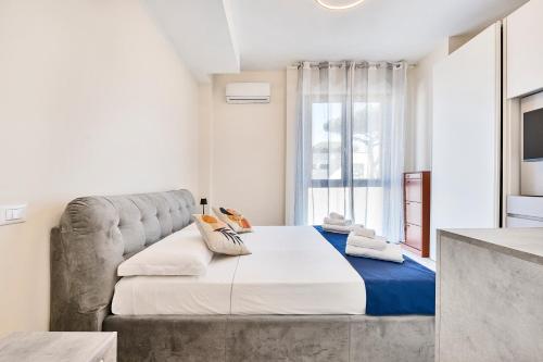 a bedroom with a large bed and a window at GOLDEN LUXE - Sunny Apartment Near the Sea in Lido di Camaiore