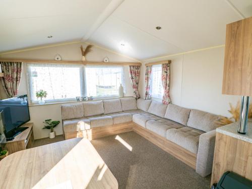 a living room with a couch and a television at North Shore Skegness, 3 Bedroom 2 Bathroom Sleeps 8 in Skegness