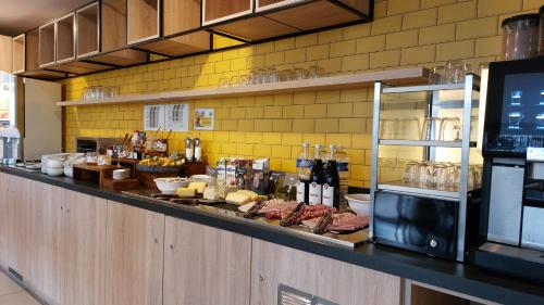 a counter in a restaurant with meat and cheese at Appart Hotel Odalys City Toulouse Centre Compans Caffarelli in Toulouse