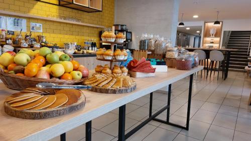 a counter with baskets of fruit and pastries on it at Appart Hotel Odalys City Toulouse Centre Compans Caffarelli in Toulouse