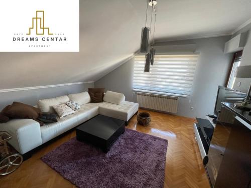 a living room with a white couch and a rug at Apartments Dreams Centar in Živinice