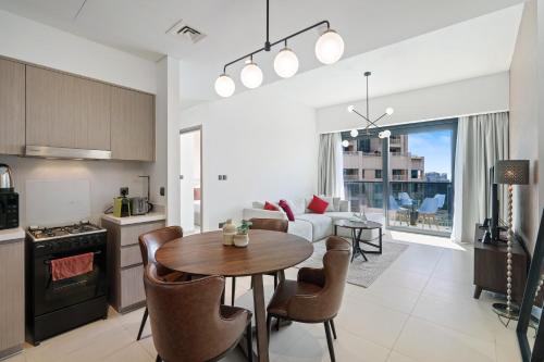 a kitchen and living room with a table and a couch at Stylish 1 Br In Downtown Near Burj Khalifa in Dubai