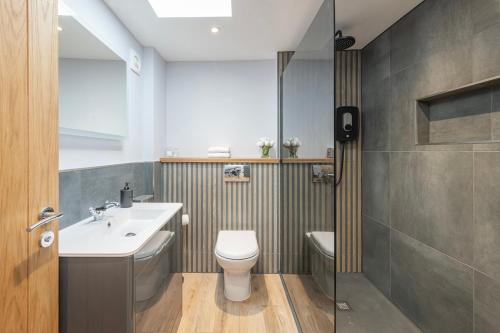 a bathroom with a toilet and a sink at Laurel Lodge - Stylish Two Bed & Free Parking in Box