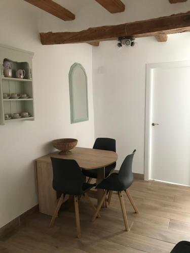 a dining room with a wooden table and chairs at Centrally located two bedroom apartment in Perelló