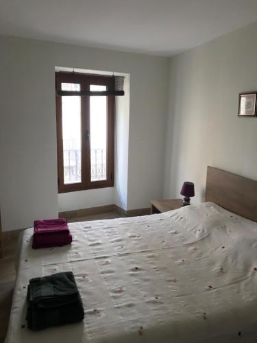 a bedroom with a large bed and a window at Centrally located two bedroom apartment in Perelló