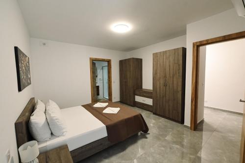 a bedroom with a bed with two towels on it at Cerviola Luxury 3 bedroom Apartments in Il-Ħamrija