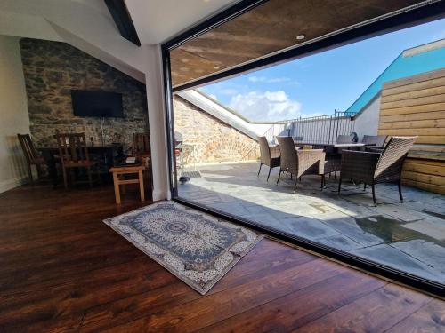 a living room with a large glass window and a table at Luxury Barbican Apartment in Plymouth