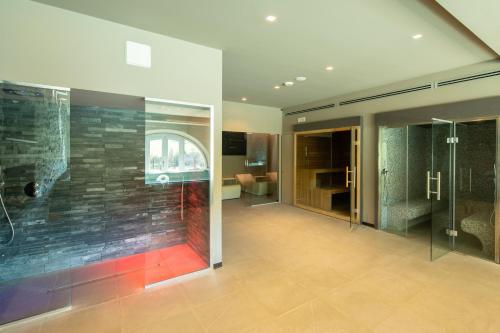 a bathroom with a walk in shower and a glass wall at Villa Francesca in Poppi