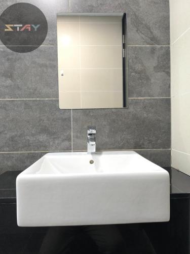 a white sink in a bathroom with a mirror at Almas Couple Urban Retreat Puteri Harbour BySTAY in Iskandar Puteri