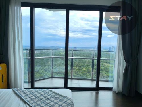 a bedroom with a large window with a view at Almas Couple Urban Retreat Puteri Harbour BySTAY in Iskandar Puteri