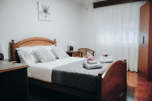 a bedroom with a bed with towels on it at Ocean Breeze in Ponta Delgada
