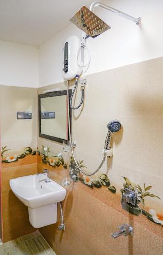 a bathroom with a shower and a sink at Palm & Wild Hiriketiya in Dickwella