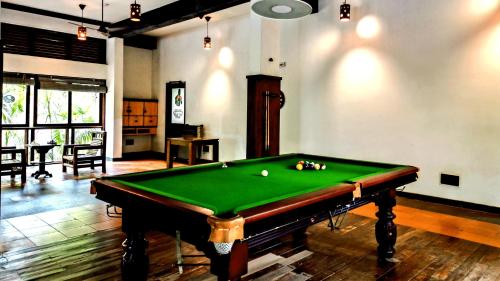 a billiard room with a pool table in it at Wayanad Silverwoods Forest Resort & Spa in Padinjarathara