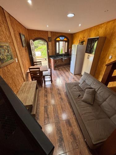 a living room with a couch and a table at Chácara Águas Claras in Monte Sião