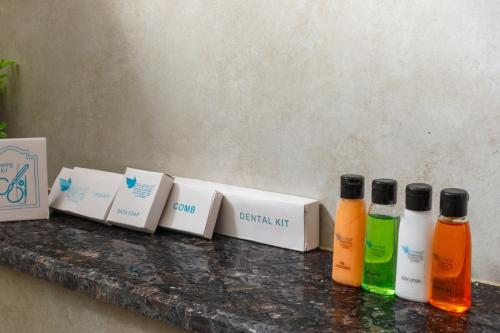 four bottles of essential oil sitting on a counter at BluO 2BHK Koramangala - Kitchen, Lift, Parking in Bengaluru